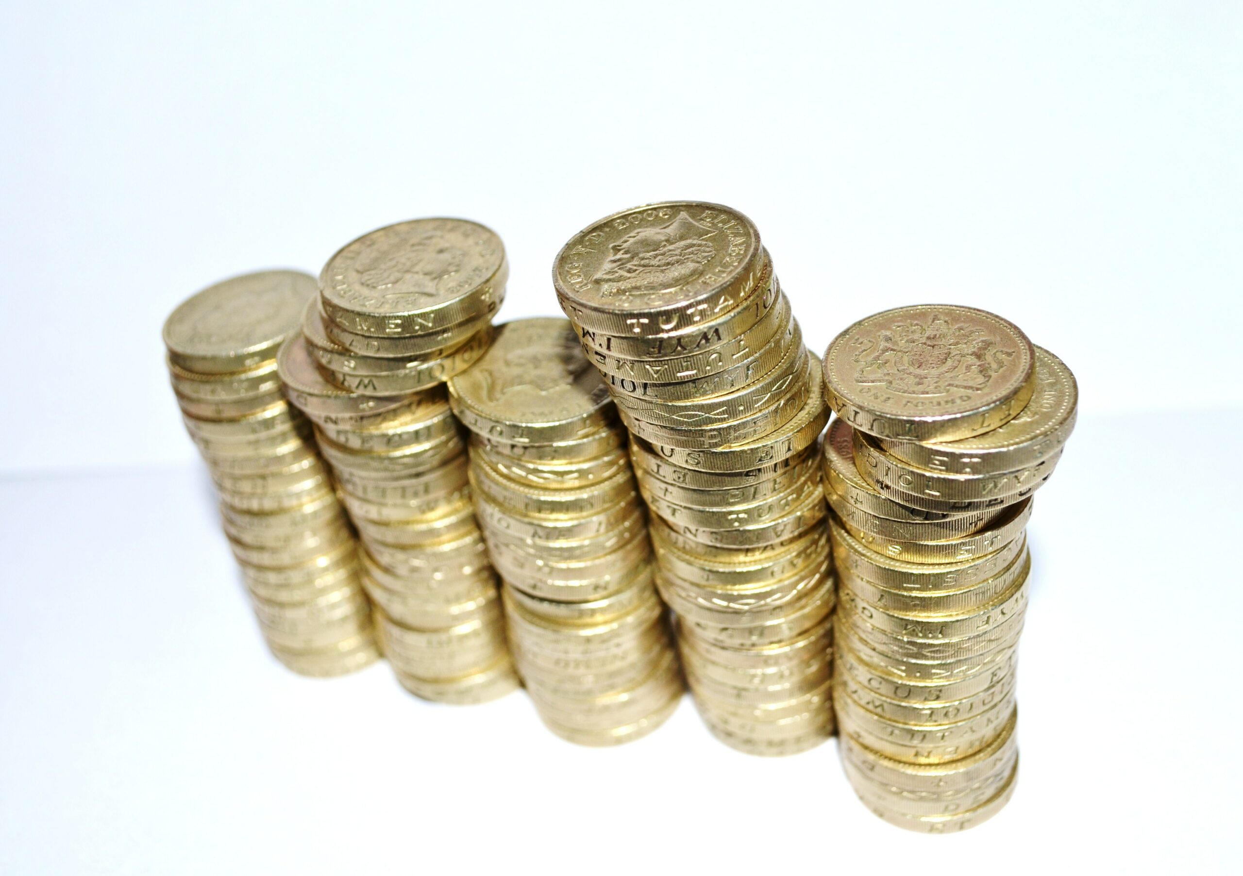 A pile of old-style £1 coins